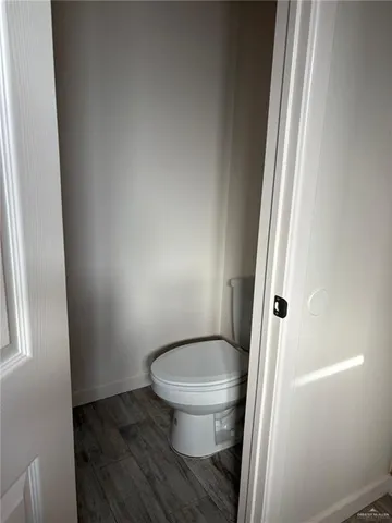 a white toilet sitting next to a shower