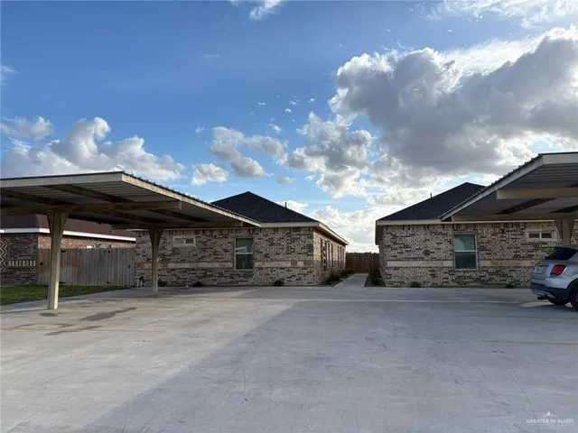 a view of a car park in front of house