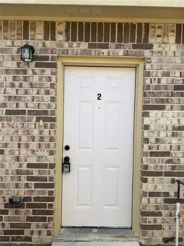 a bathroom with a granite countertop sink a mirror and shower