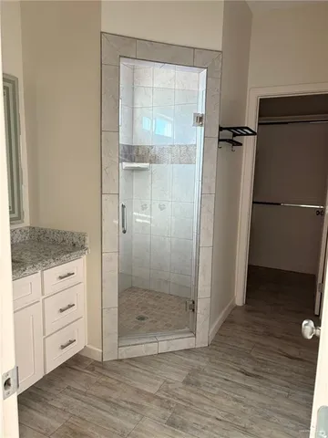 a bathroom with a shower and a sink