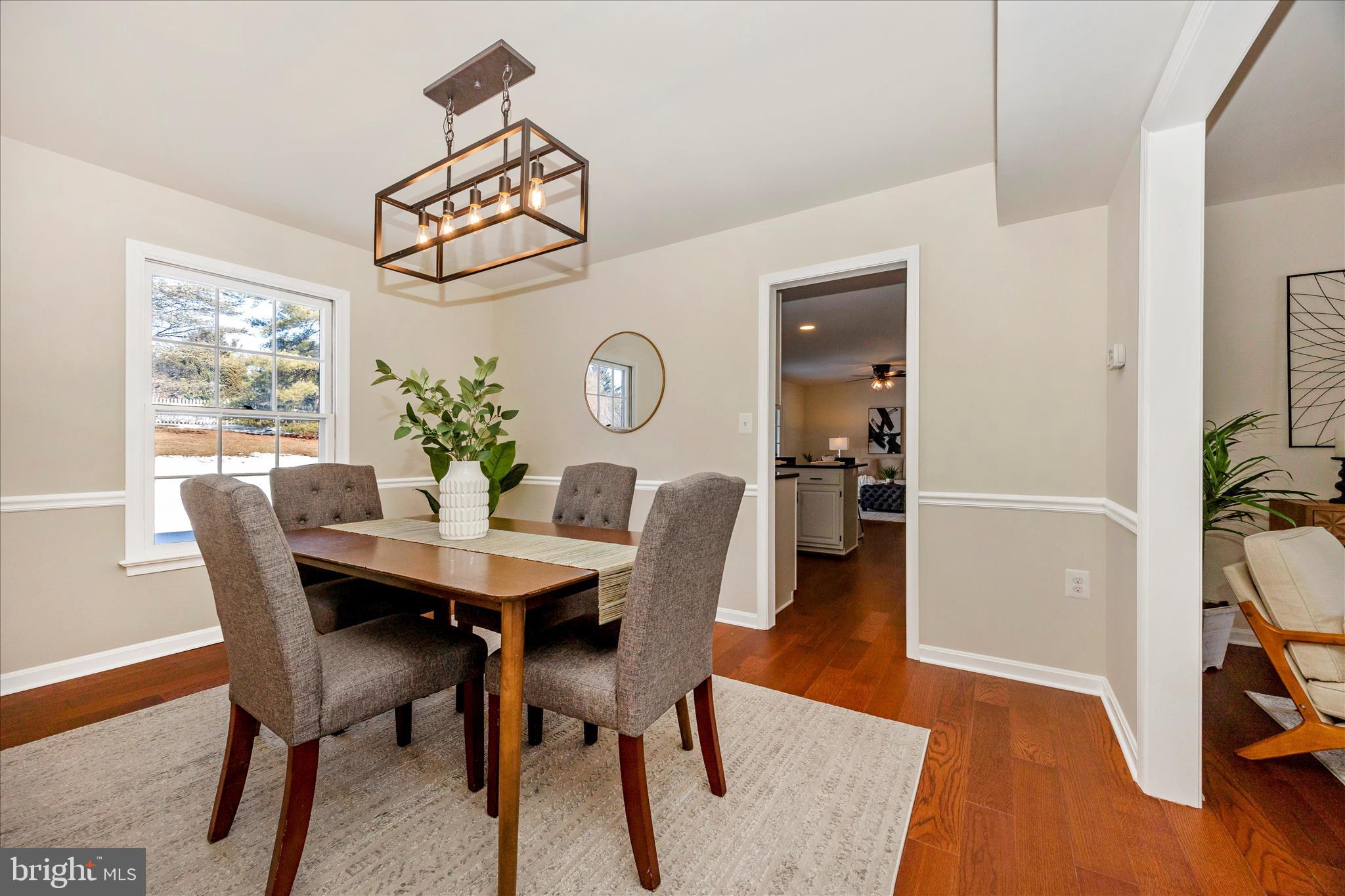 6630 Fox Meade Court Frederick, MD 21702 - Photo 15 of 84 a view of a dining room with furniture window and wooden floor