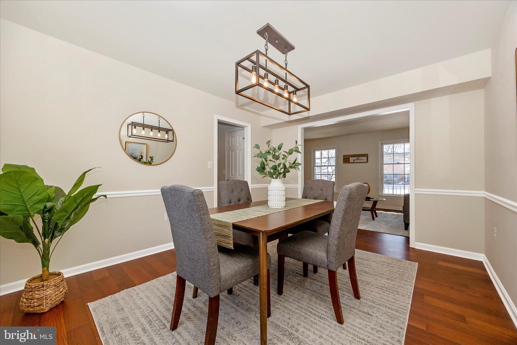 6630 Fox Meade Court Frederick, MD 21702 - Photo 16 of 84 a view of a dining room with furniture and wooden floor