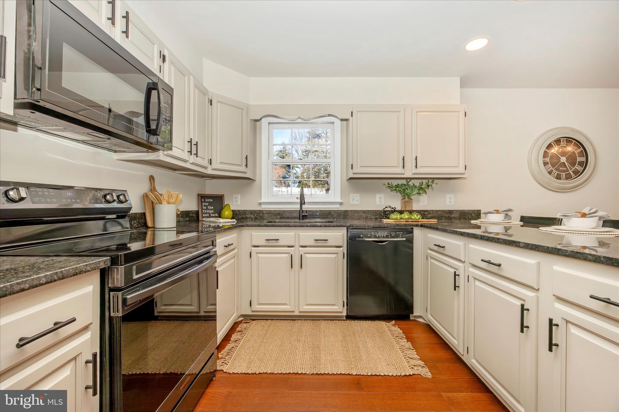 6630 Fox Meade Court Frederick, MD 21702 - Photo 19 of 84 a kitchen with a stove a sink and a microwave