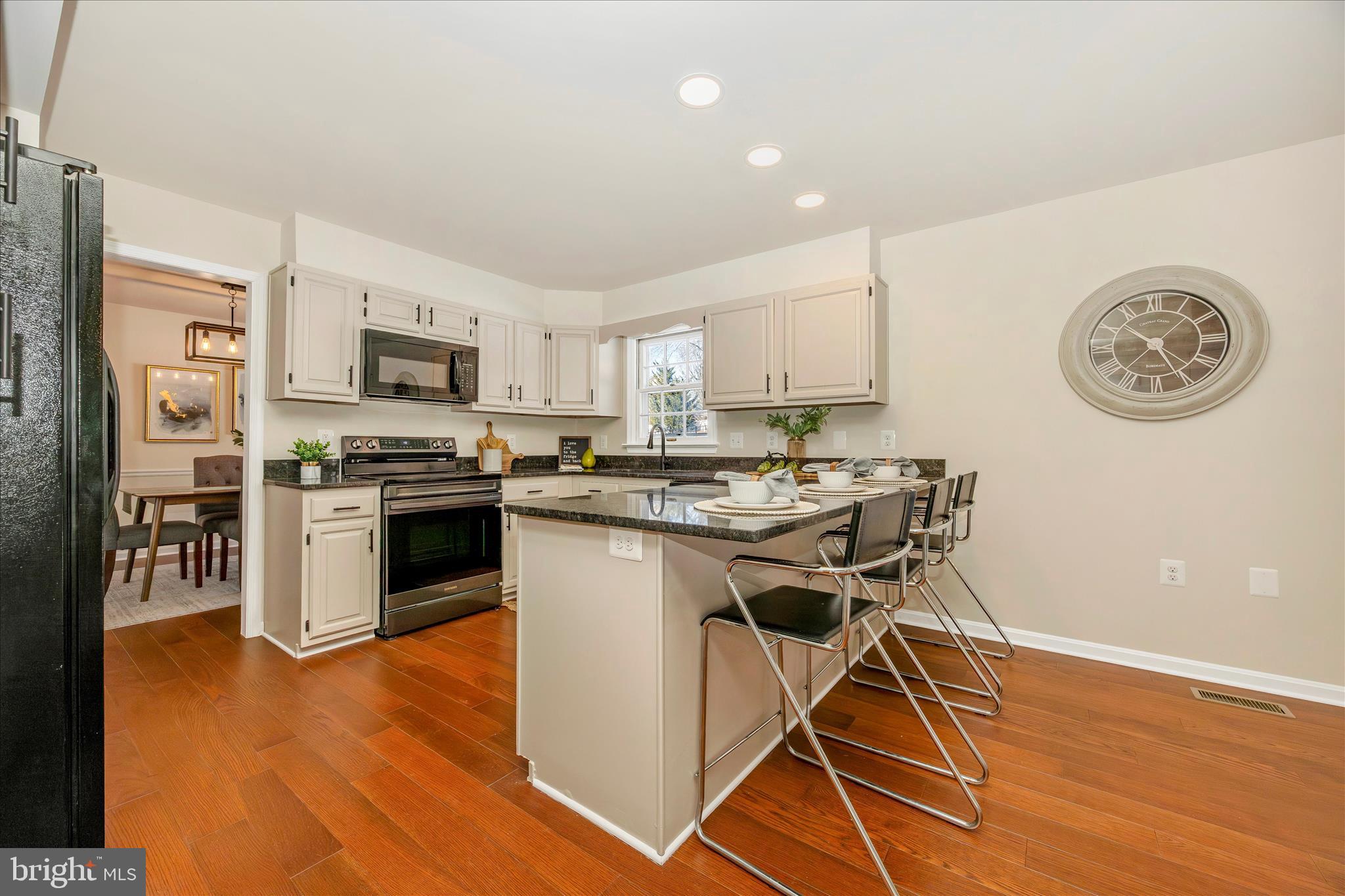 6630 Fox Meade Court Frederick, MD 21702 - Photo 20 of 84 a kitchen with a table chairs a sink dishwasher stove and refrigerator with wooden floor