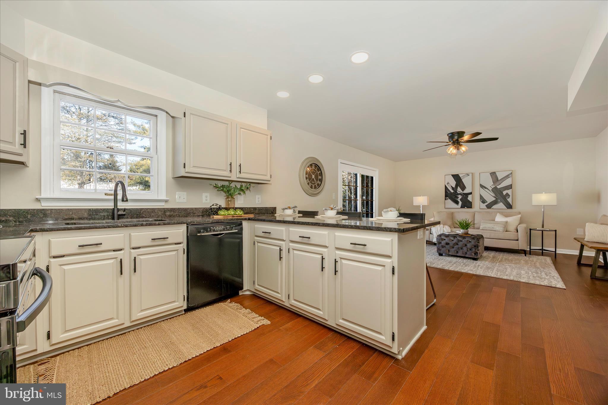 6630 Fox Meade Court Frederick, MD 21702 - Photo 22 of 84 a kitchen with a sink cabinets and wooden floor