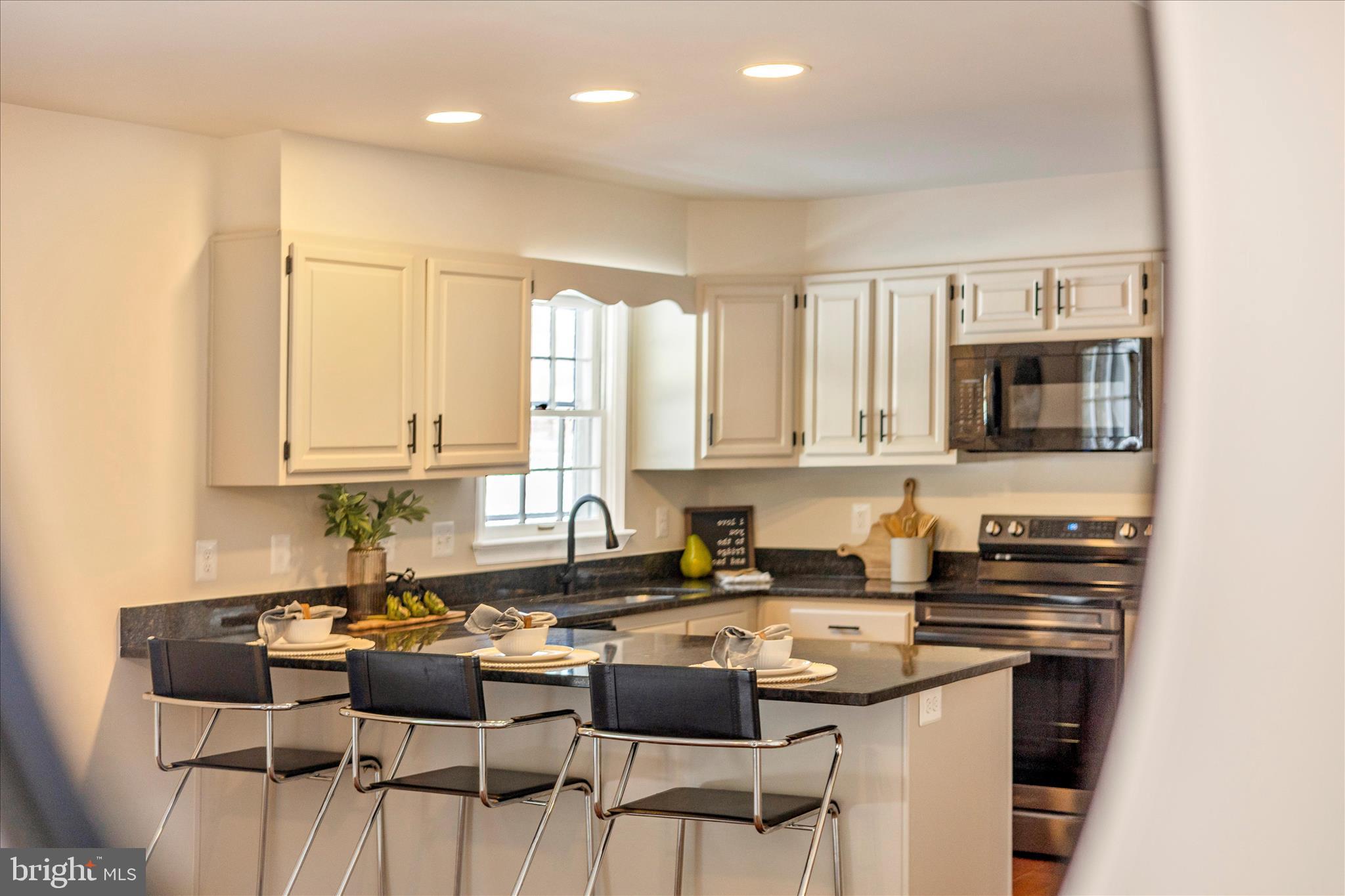 6630 Fox Meade Court Frederick, MD 21702 - Photo 32 of 84 a kitchen with a stove a sink and a refrigerator