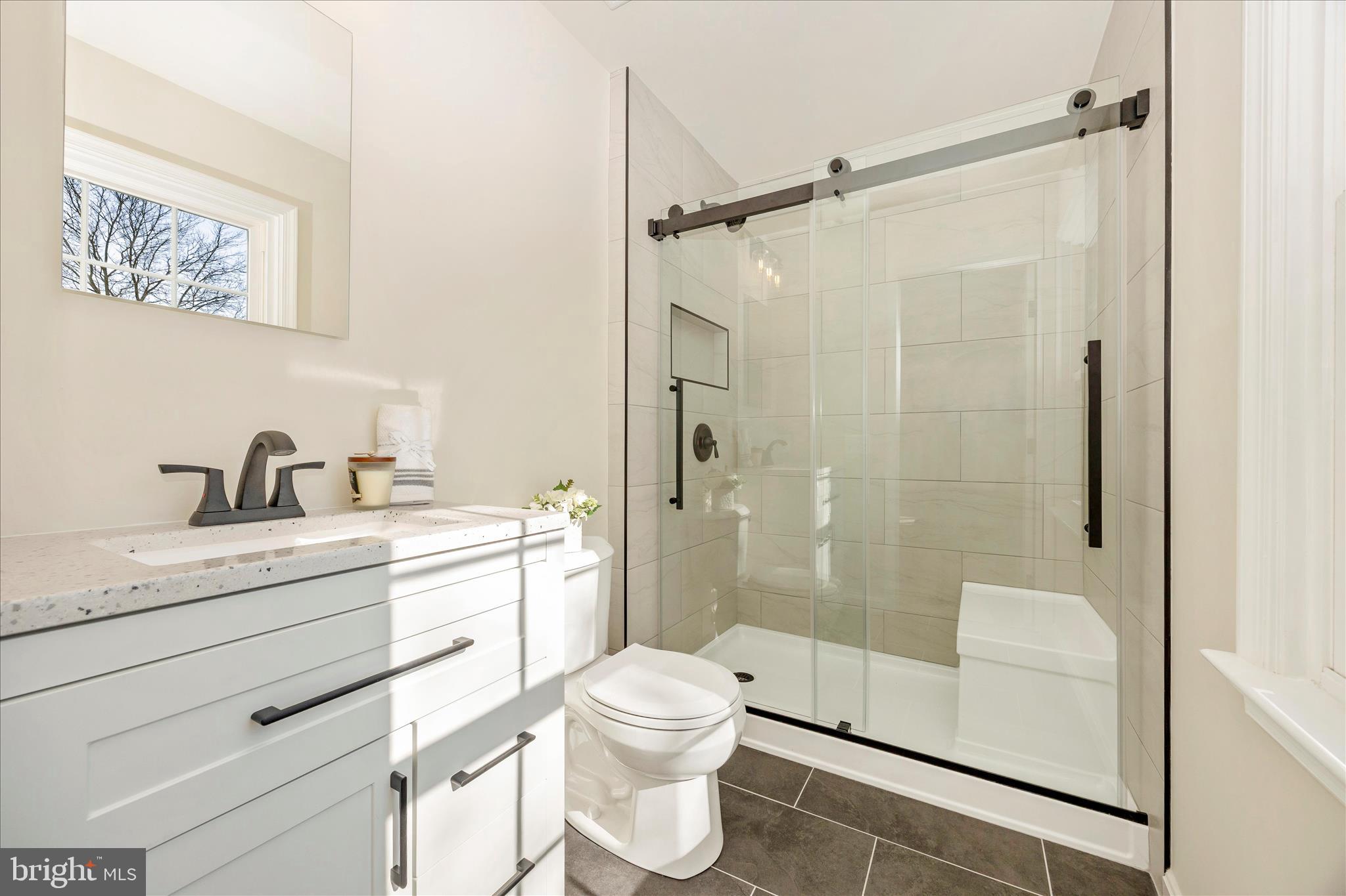 6630 Fox Meade Court Frederick, MD 21702 - Photo 38 of 84 a bathroom with a granite countertop sink a toilet and shower