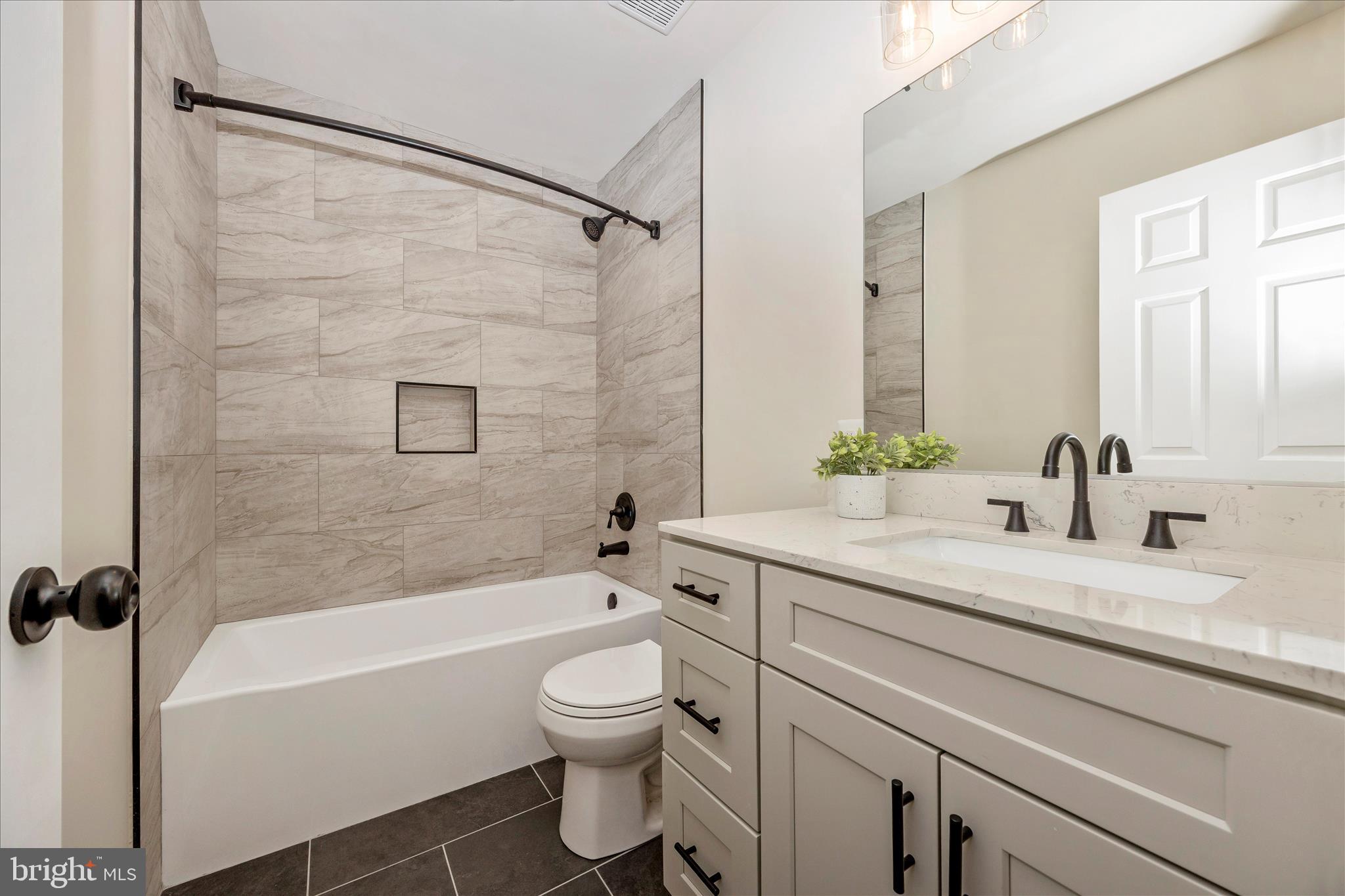 6630 Fox Meade Court Frederick, MD 21702 - Photo 45 of 84 a bathroom with a granite countertop sink toilet and shower