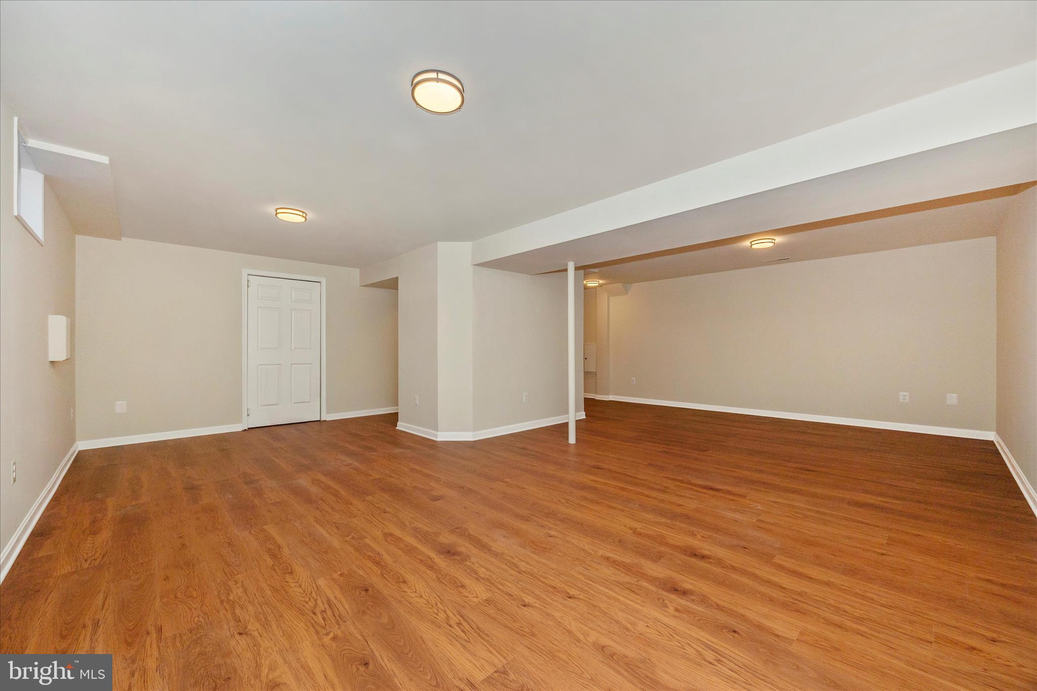 6630 Fox Meade Court Frederick, MD 21702 - Photo 47 of 84 a view of an empty room with wooden floor and a window