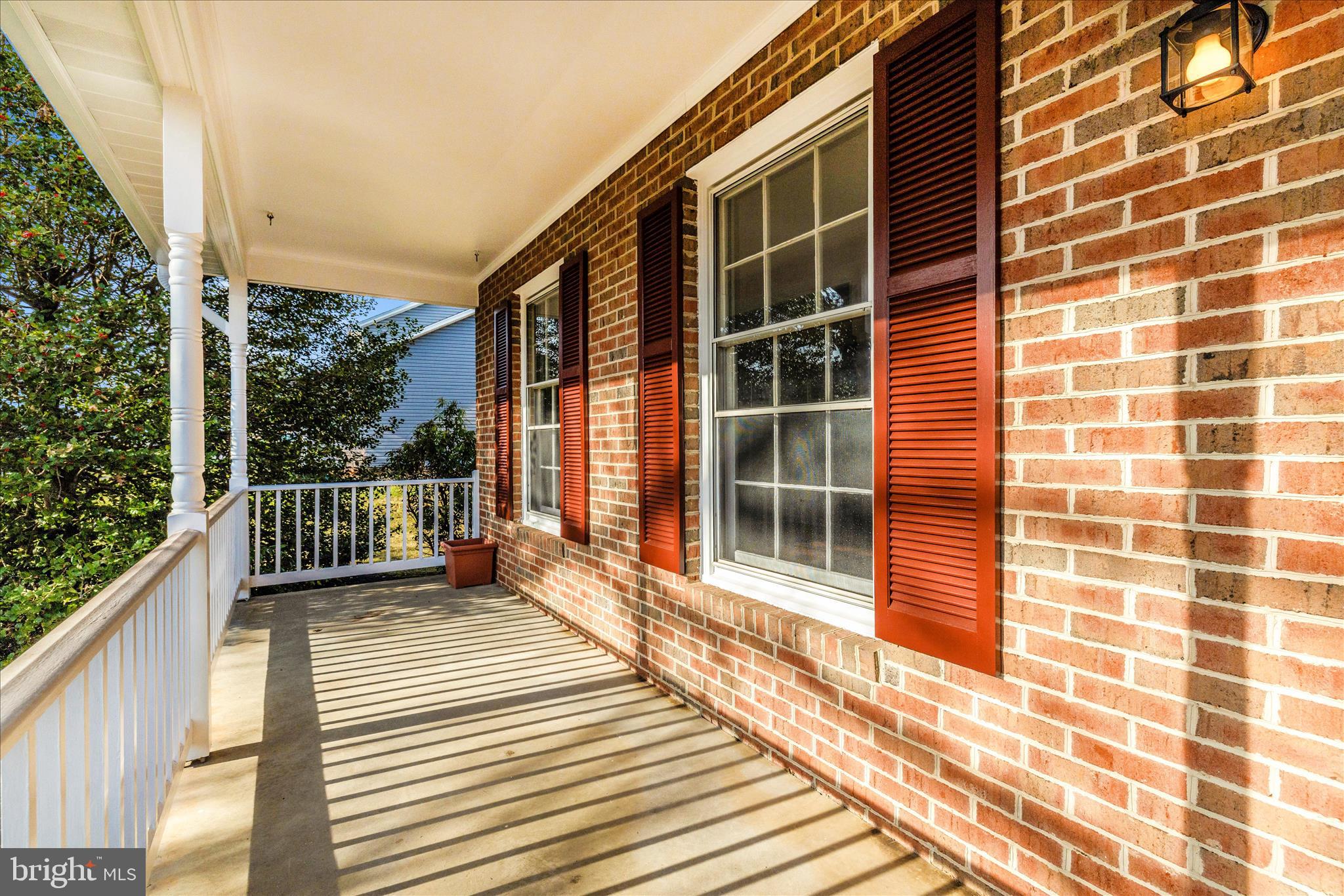6630 Fox Meade Court Frederick, MD 21702 - Photo 57 of 84 a view of a balcony with a floor to ceiling window and wooden floor