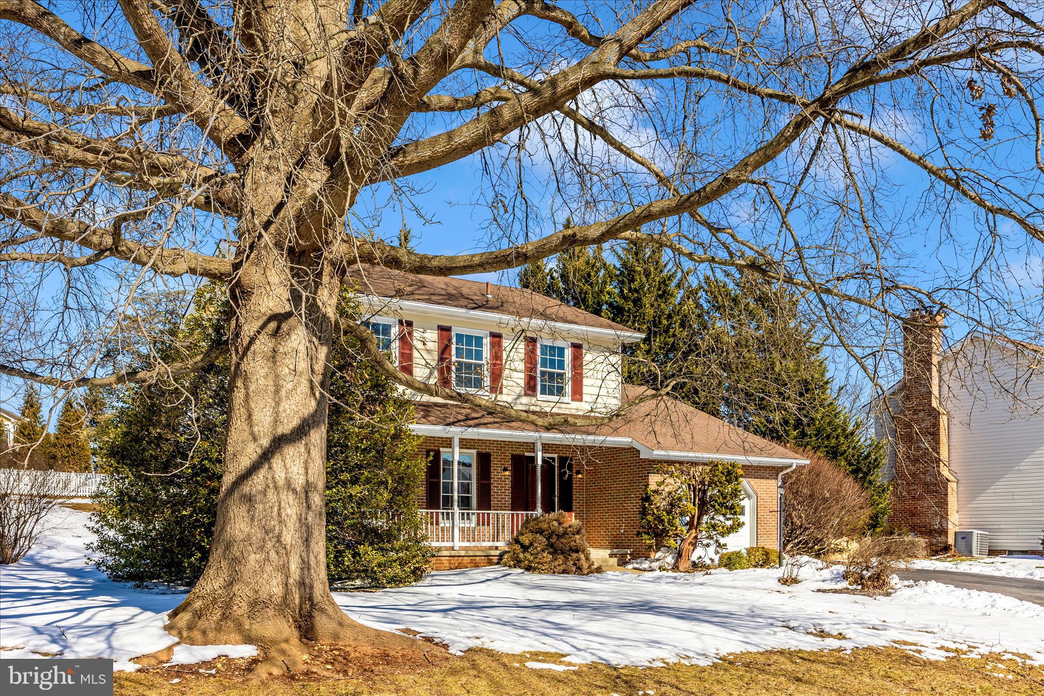 6630 Fox Meade Court Frederick, MD 21702 - Photo 59 of 84 a front view of a house with a yard covered with snow