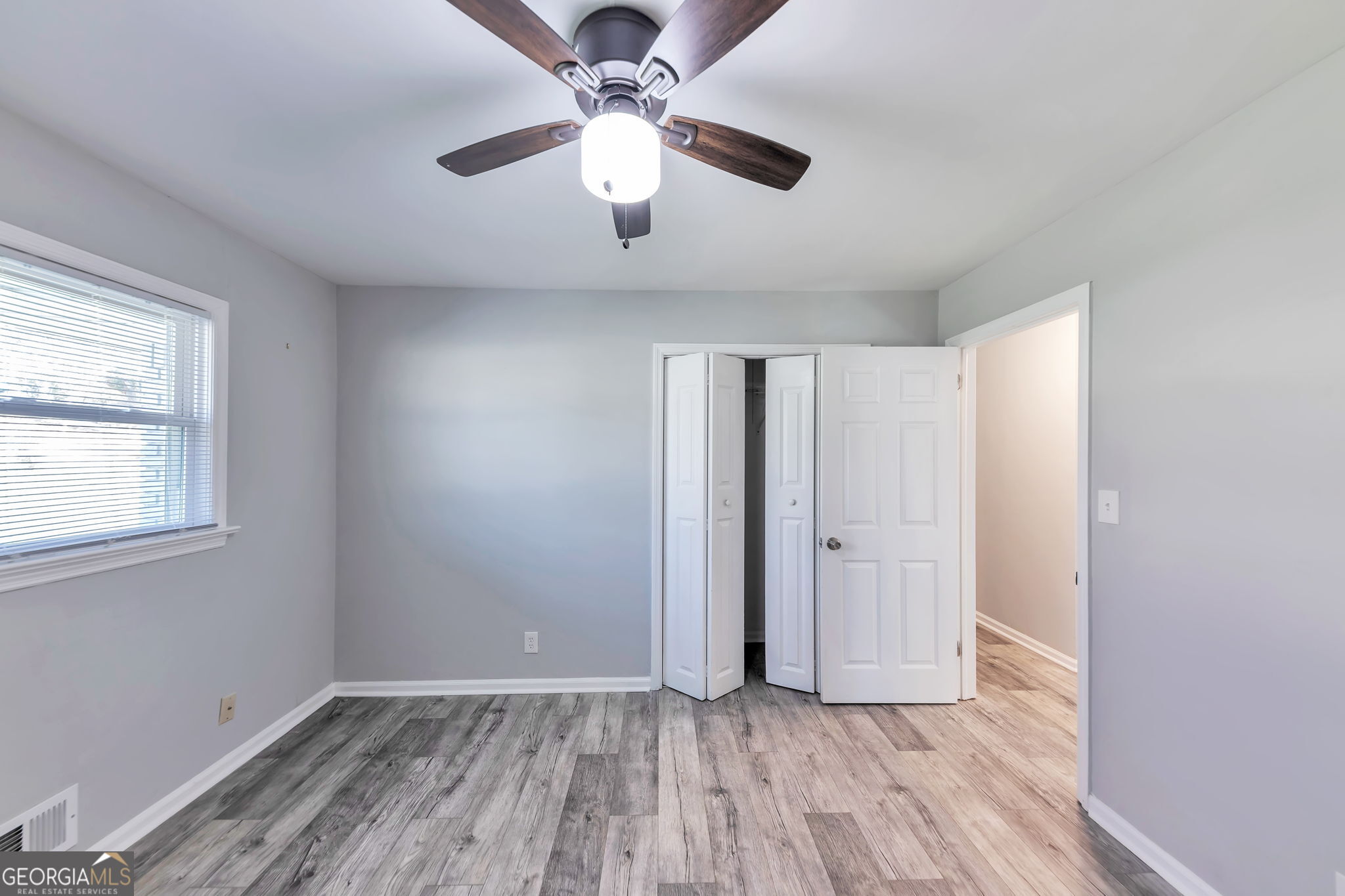 2764 Veltre Place Southwest Atlanta, GA 30311 - Photo 17 of 30 wooden floor in an empty room with a window