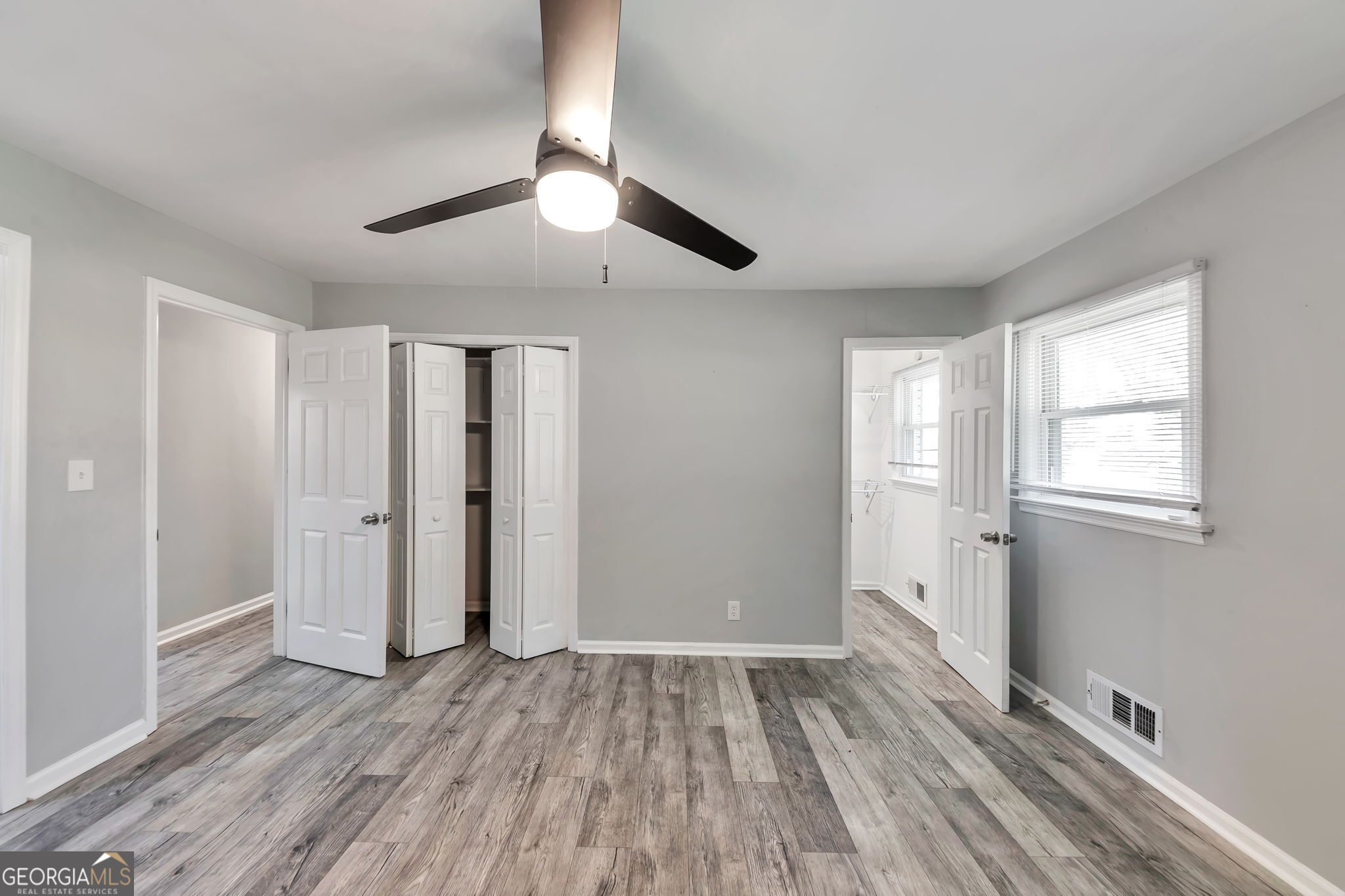 2764 Veltre Place Southwest Atlanta, GA 30311 - Photo 20 of 30 a view of an empty room with wooden floor and a window