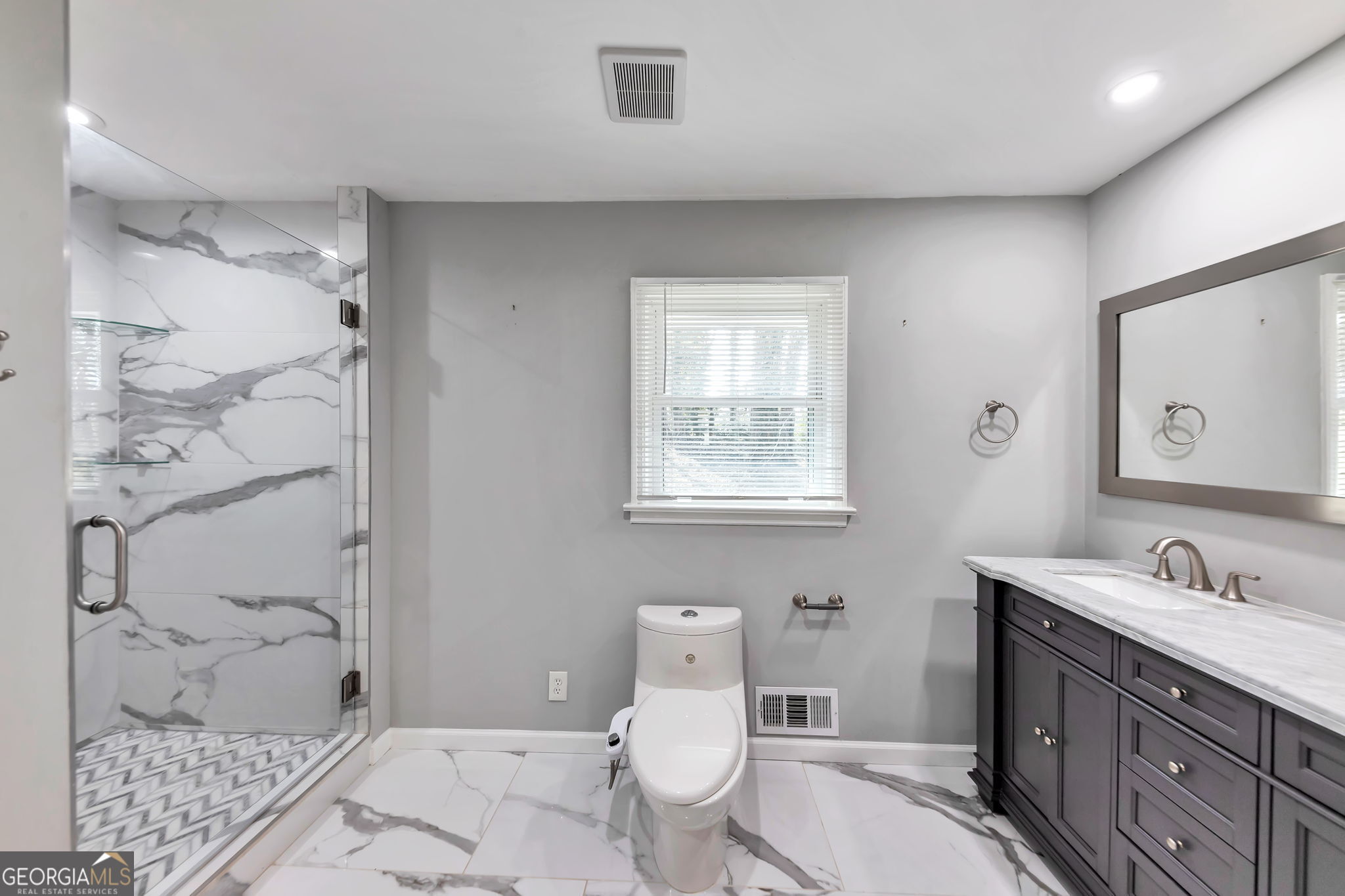 2764 Veltre Place Southwest Atlanta, GA 30311 - Photo 23 of 30 a bathroom with a granite countertop toilet sink and mirror