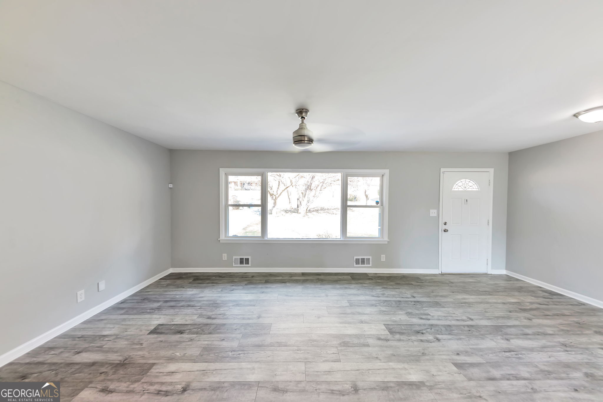 2764 Veltre Place Southwest Atlanta, GA 30311 - Photo 8 of 30 wooden floor in an empty room with a window