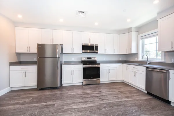 a kitchen with a refrigerator stove and microwave