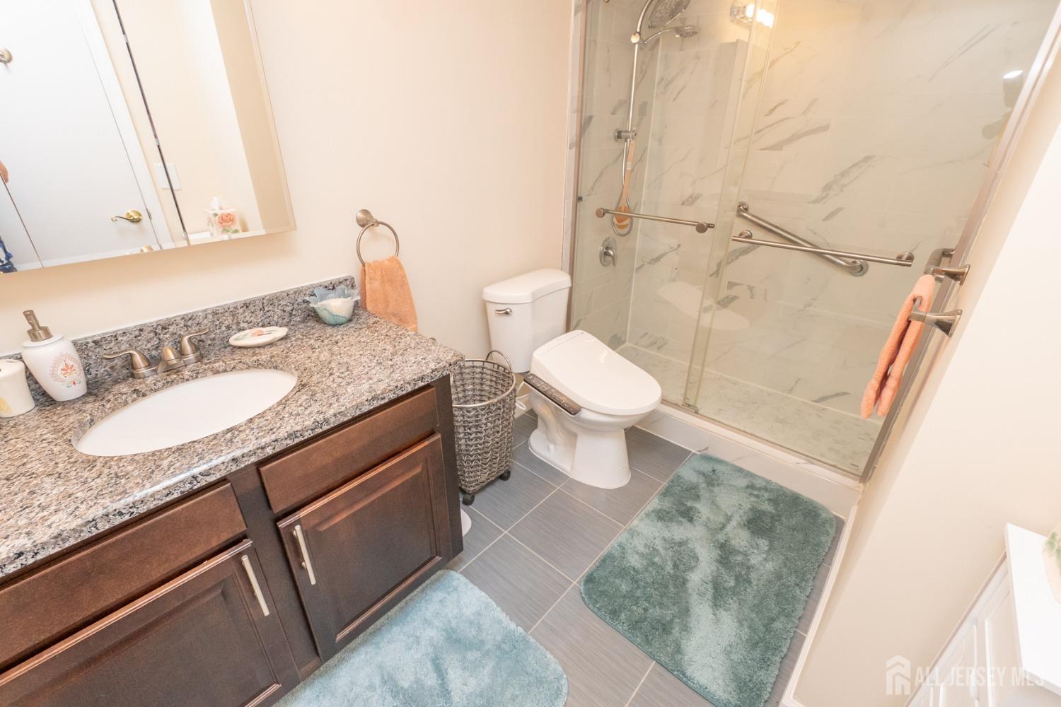 1405 Plymouth Road North Brunswick, NJ 08902 - Photo 20 of 32 a bathroom with a granite countertop sink toilet and shower