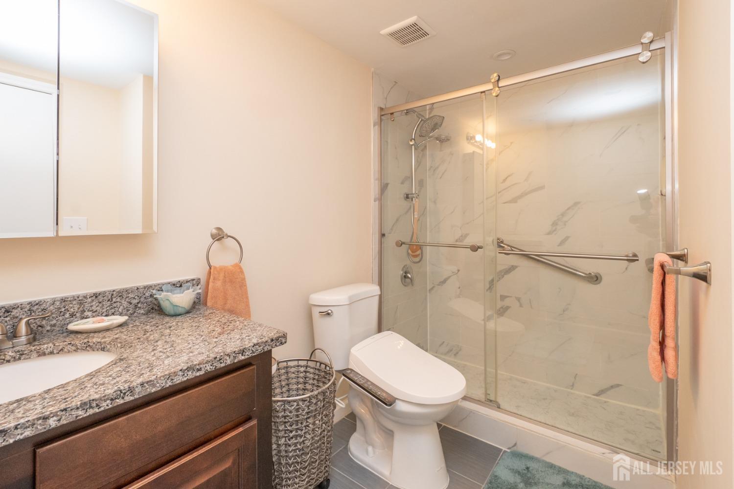 1405 Plymouth Road North Brunswick, NJ 08902 - Photo 21 of 32 a bathroom with a granite countertop sink toilet and shower