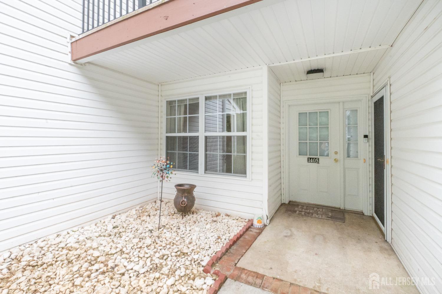 1405 Plymouth Road North Brunswick, NJ 08902 - Photo 3 of 32 a view of a porch with a wooden door