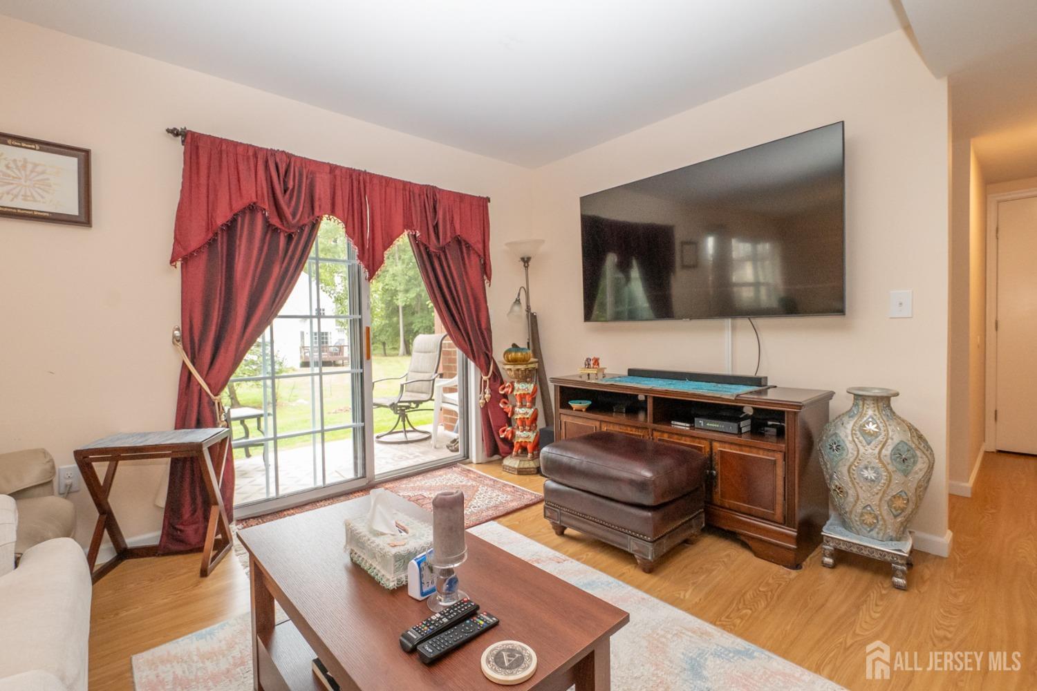 1405 Plymouth Road North Brunswick, NJ 08902 - Photo 7 of 32 a living room with furniture and a flat screen tv