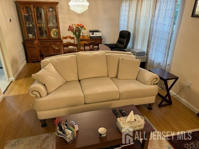 1405 Plymouth Road North Brunswick, NJ 08902 - Photo 9 of 32 a living room with furniture and wooden floor
