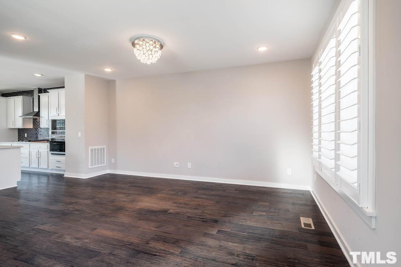 444 Rally Point Place Wake Forest, NC 27587 - Photo 14 of 38 a view of an empty room with wooden floor and a window
