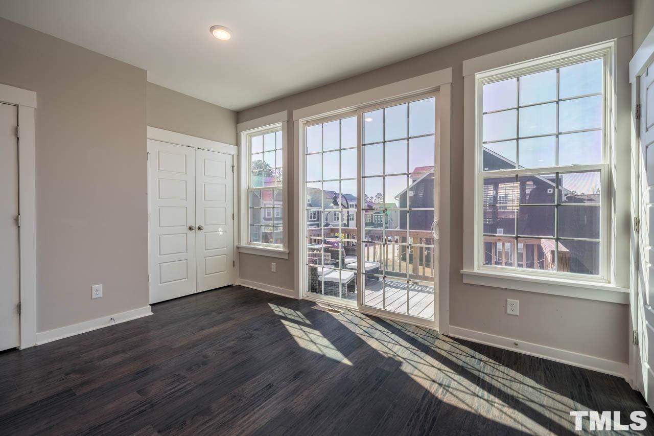 444 Rally Point Place Wake Forest, NC 27587 - Photo 21 of 38 wooden floor and windows in an empty room