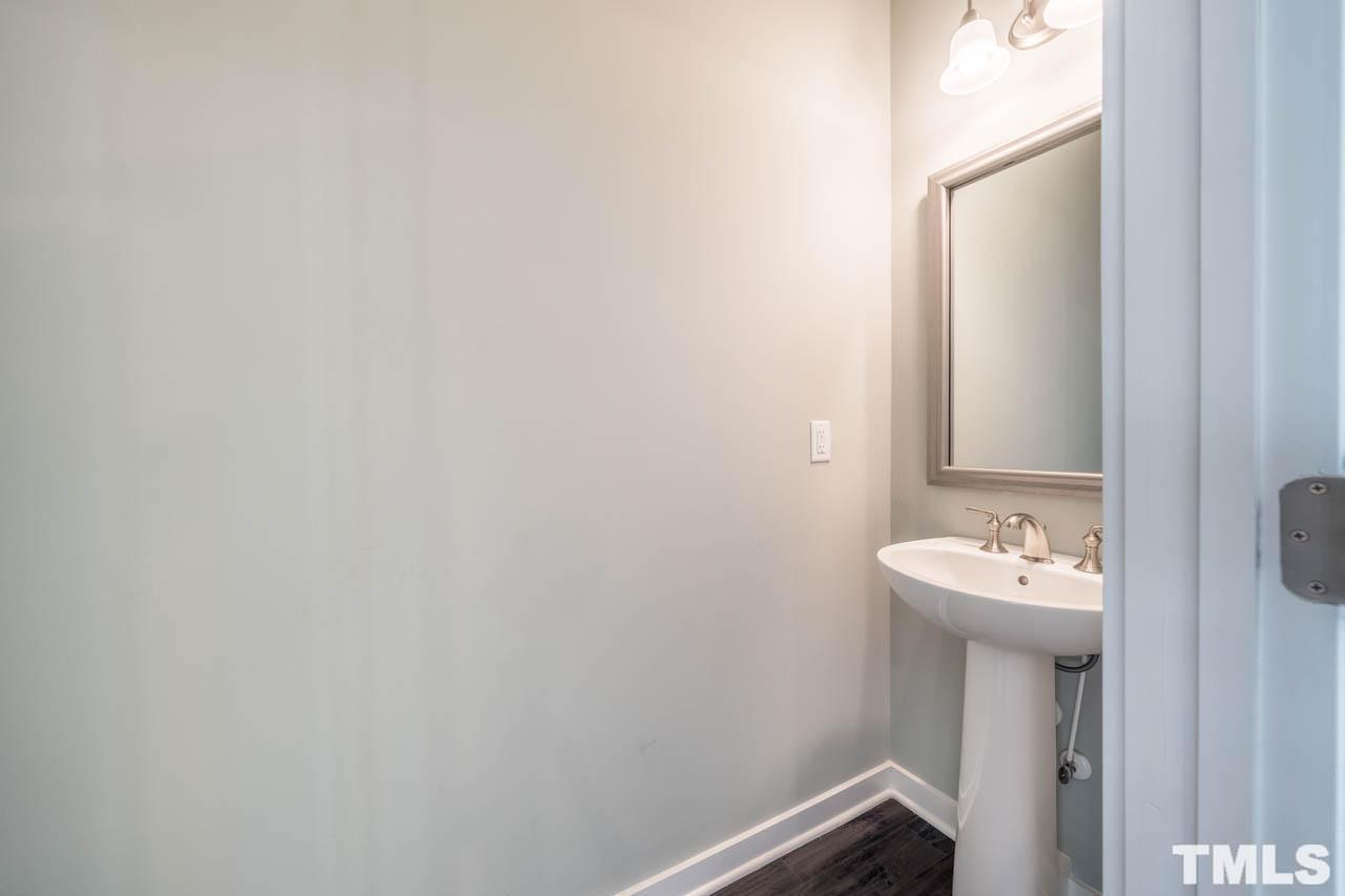 444 Rally Point Place Wake Forest, NC 27587 - Photo 22 of 38 a bathroom with a sink and a mirror