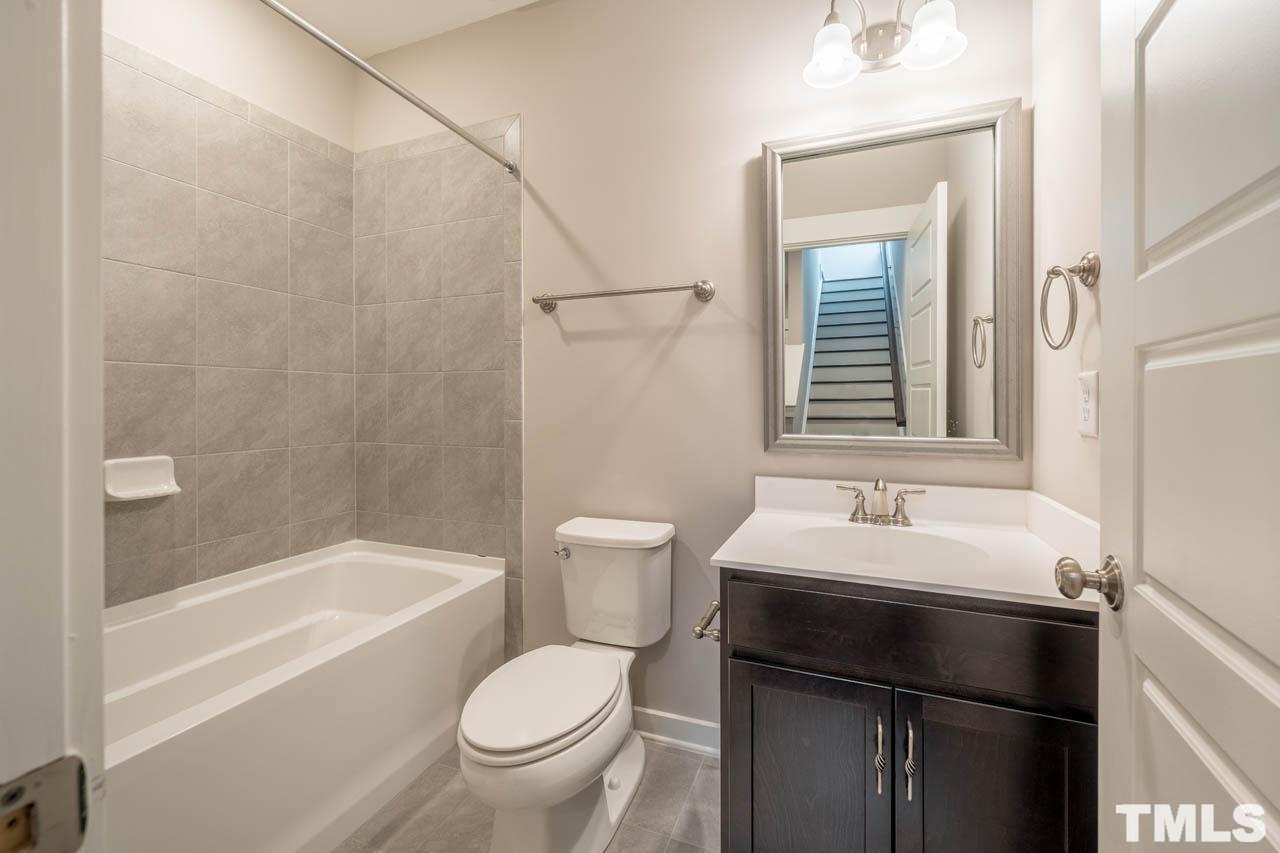 444 Rally Point Place Wake Forest, NC 27587 - Photo 24 of 38 a bathroom with a sink a toilet and a bathtub