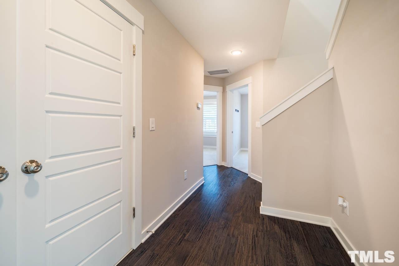 444 Rally Point Place Wake Forest, NC 27587 - Photo 30 of 38 a view of a hallway with wooden floor