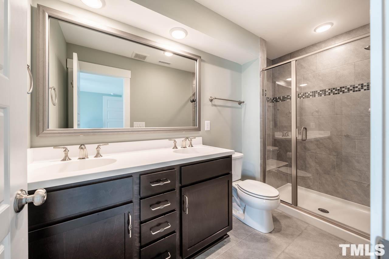 444 Rally Point Place Wake Forest, NC 27587 - Photo 31 of 38 a bathroom with a sink toilet and shower