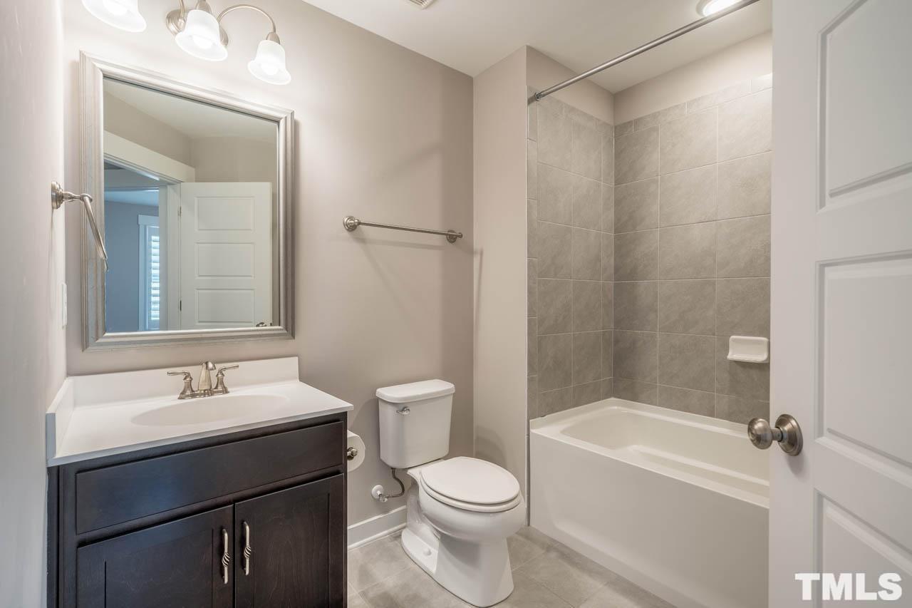 444 Rally Point Place Wake Forest, NC 27587 - Photo 33 of 38 a bathroom with a sink toilet and shower