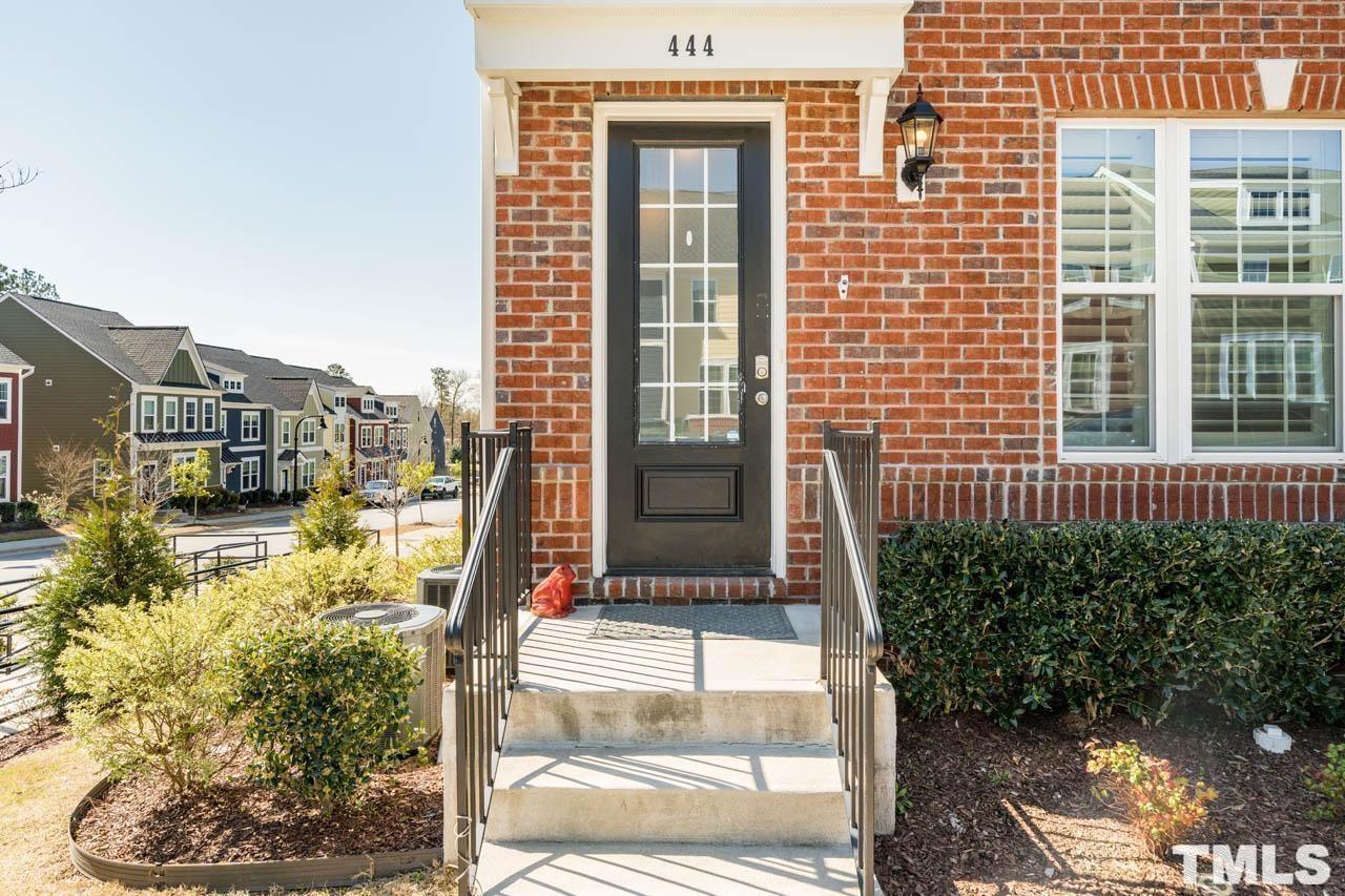 444 Rally Point Place Wake Forest, NC 27587 - Photo 6 of 38 a view of a brick house with a large windows and plants