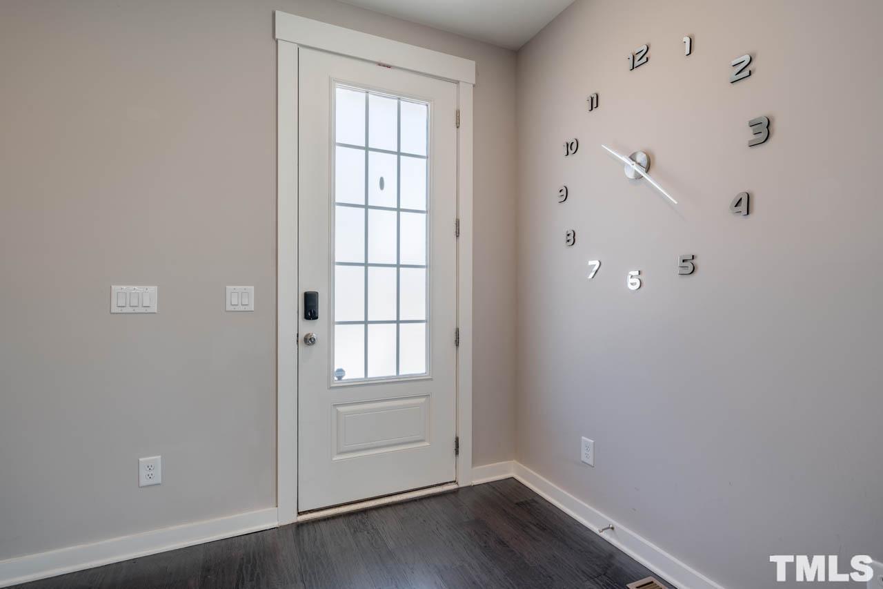444 Rally Point Place Wake Forest, NC 27587 - Photo 8 of 38 an empty room with wooden floor and windows