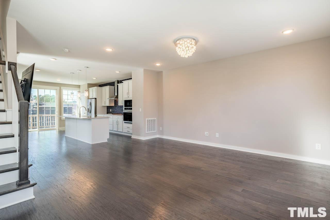 444 Rally Point Place Wake Forest, NC 27587 - Photo 9 of 38 a view of a kitchen with wooden floor and a large window