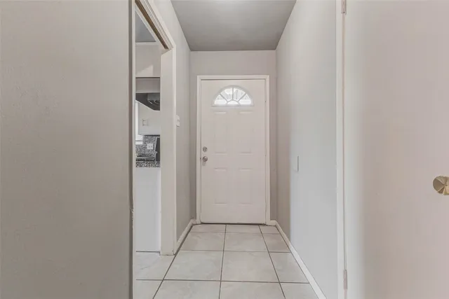an empty room with windows and ceiling fan