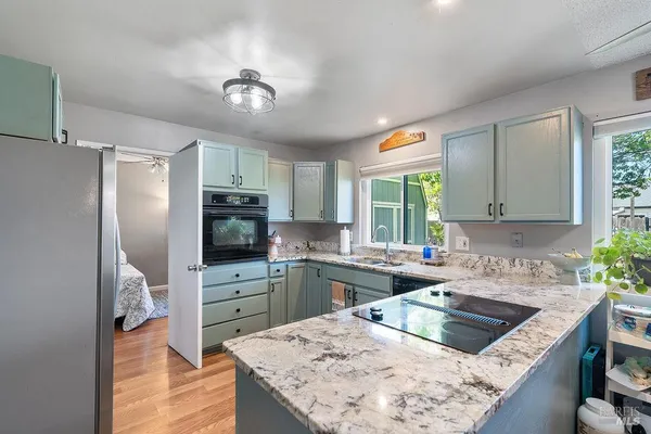 a kitchen with refrigerator cabinets and a sink