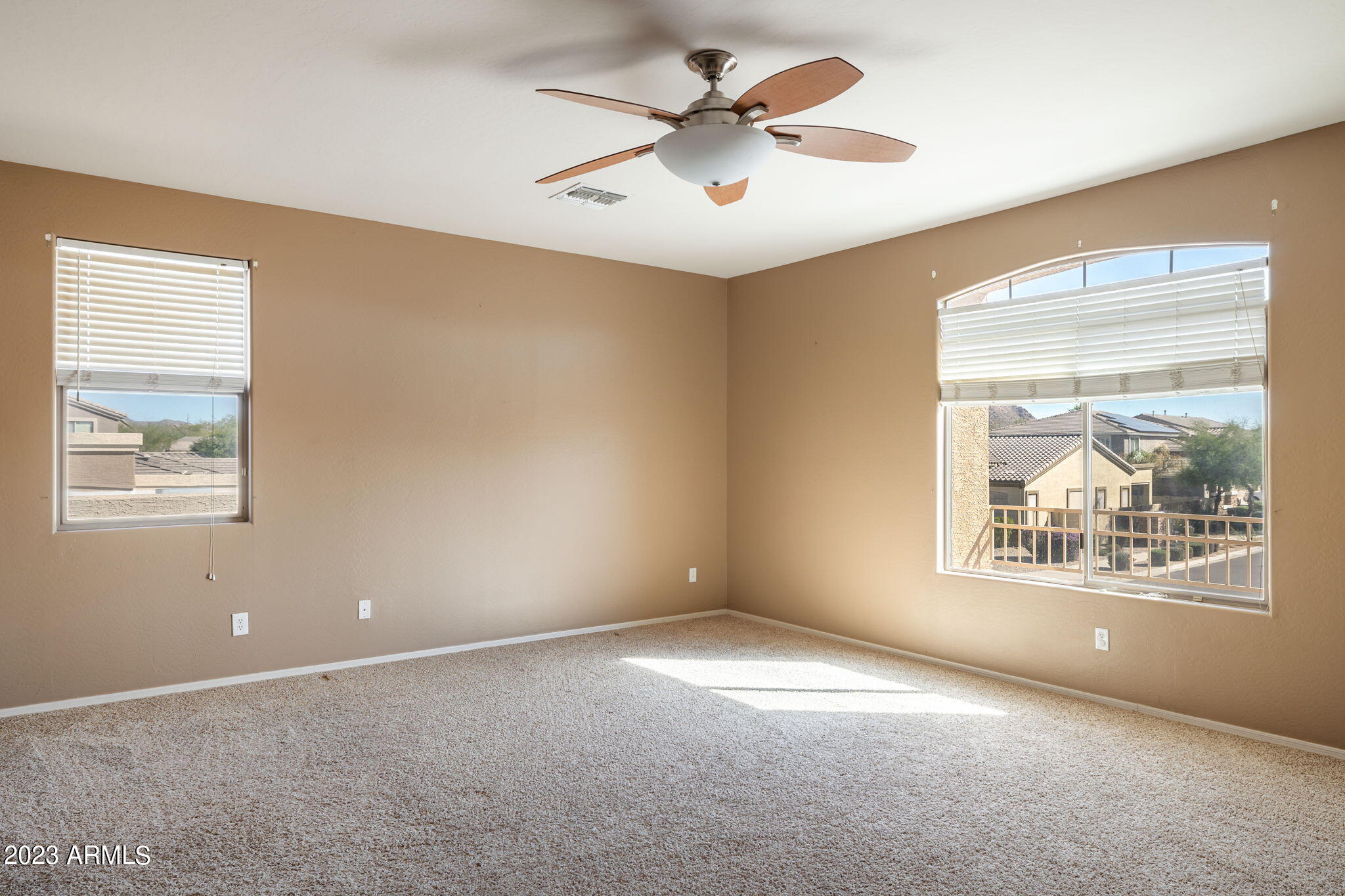 3344 West Montello Road Phoenix, AZ 85086 - Photo 13 of 38 an empty room with windows and ceiling fan