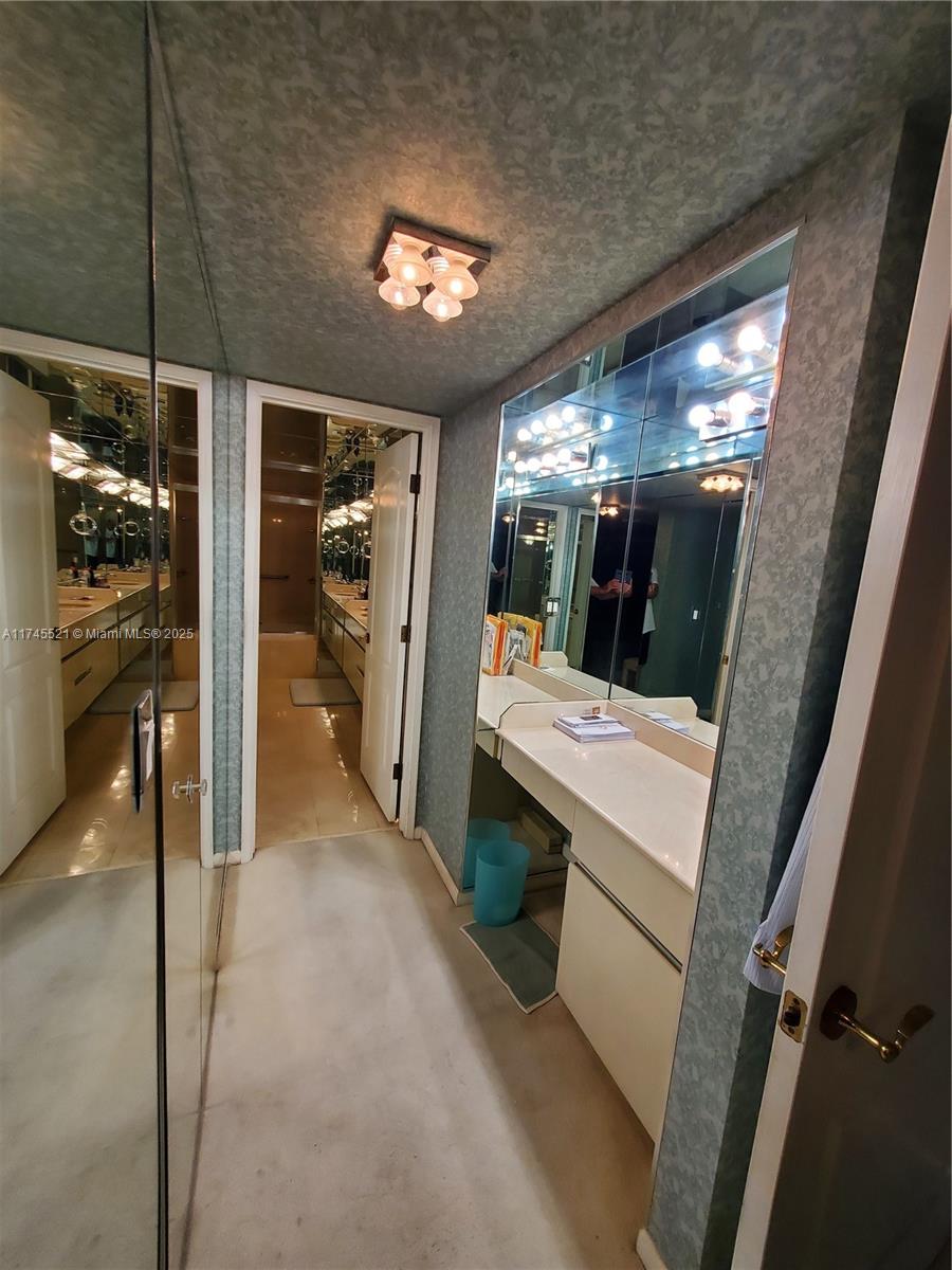 5757 Collins Avenue, Unit 1902 Miami Beach, FL 33140 - Photo 12 of 25 a view of a hallway with washer and dryer