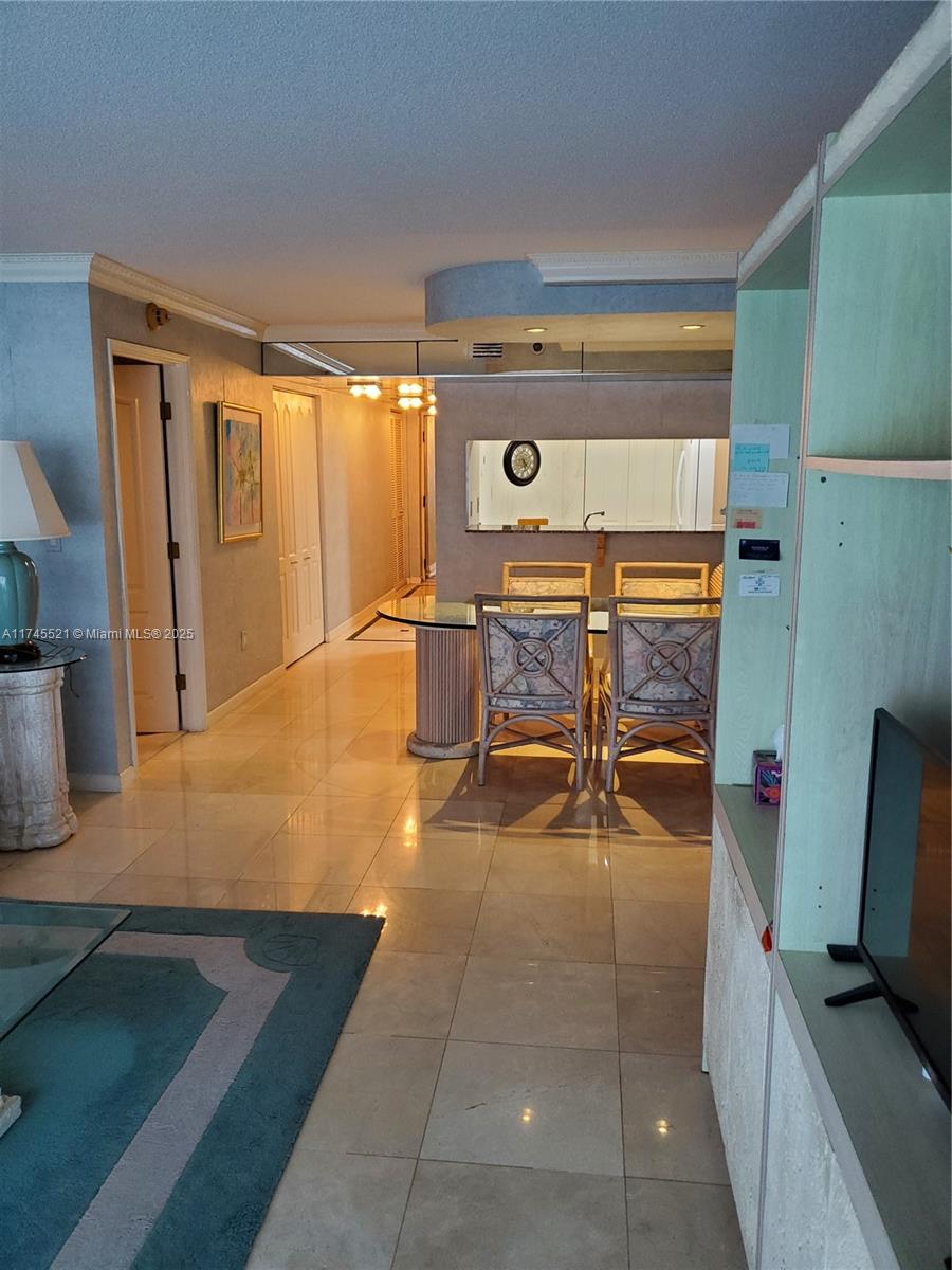 5757 Collins Avenue, Unit 1902 Miami Beach, FL 33140 - Photo 9 of 25 a room with wooden floor and furniture