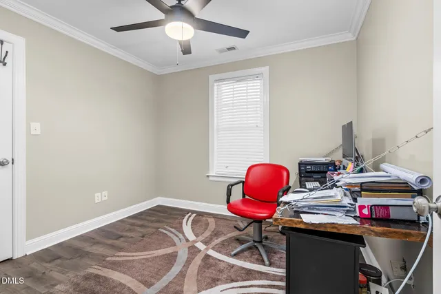 a view of a workspace with furniture and a window