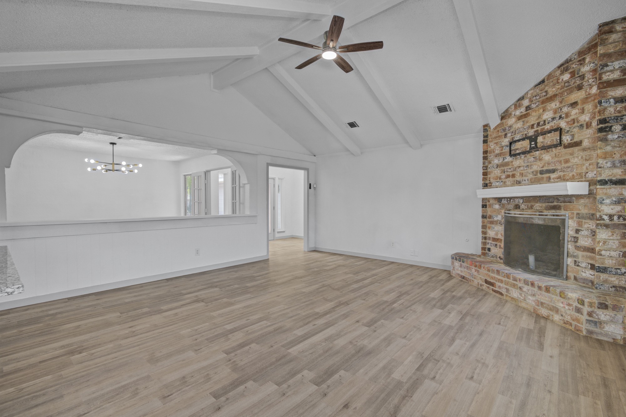 13747 Rampchester Lane Houston, TX 77015 - Photo 10 of 24 a view of empty room with wooden floor and fireplace