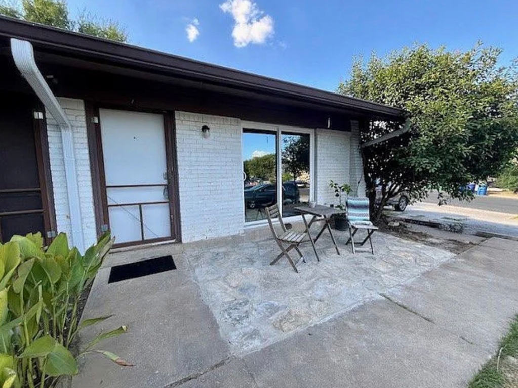 1303 Hollow Creek Drive, Unit 1 Austin, TX 78704 - Photo 19 of 19 a backyard of a house with table and chairs