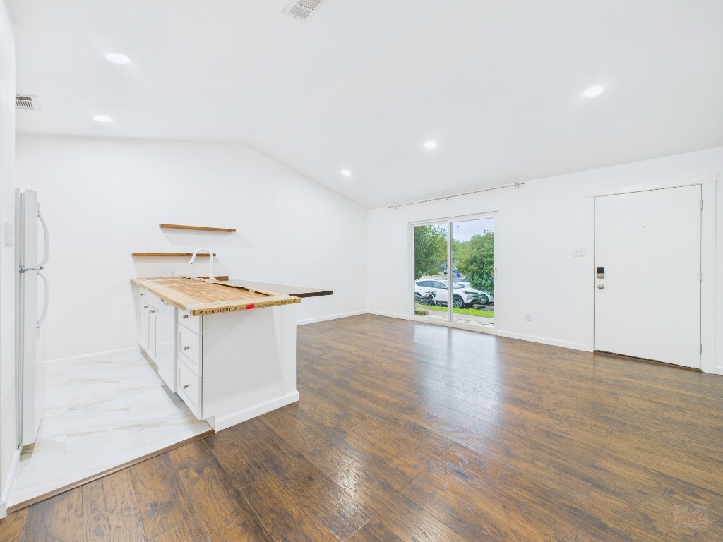 1303 Hollow Creek Drive, Unit 1 Austin, TX 78704 - Photo 5 of 19 a kitchen with cabinets and wooden floor