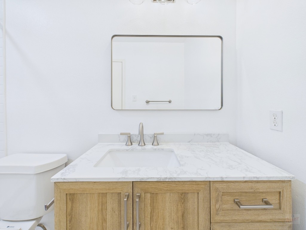1303 Hollow Creek Drive, Unit 1 Austin, TX 78704 - Photo 8 of 19 a bathroom with a sink and a toilet