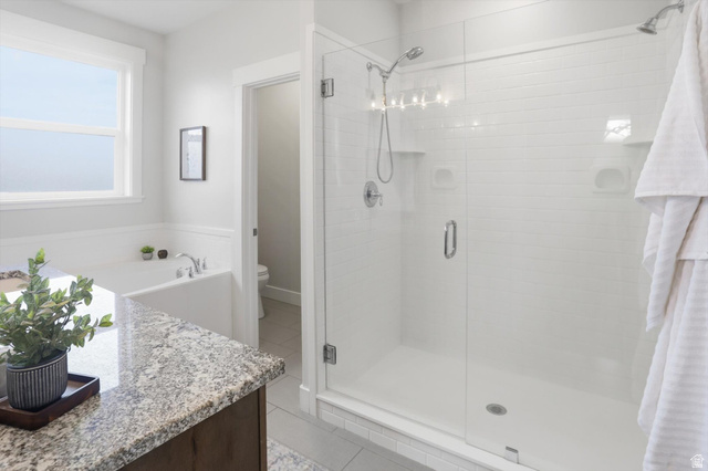 1009 High Creek Road Cove, UT 84320 - Photo 32 of 79 master bathroom featuring light tile patterned flooring, vanity, a dual shower stall, and a bath
