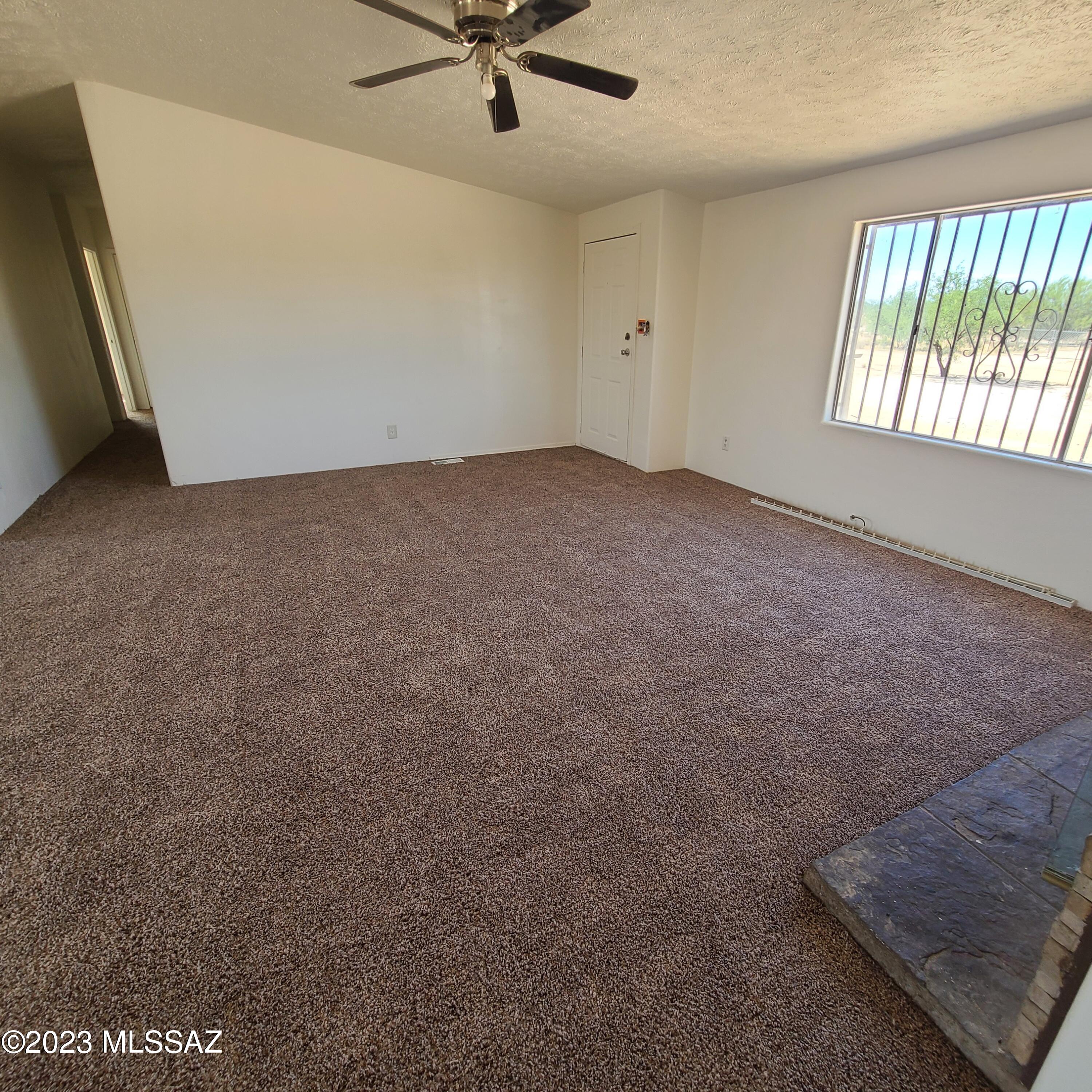 8896 South Marstellar Road Tucson, AZ 85736 - Photo 6 of 39 an empty room with a window