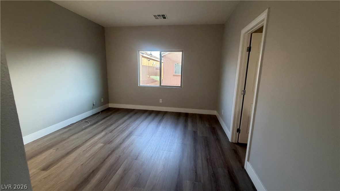 9453 Alma Ridge Avenue Las Vegas, NV 89178 - Photo 7 of 25 A well-lit room showcasing a single window and durable laminate flooring.