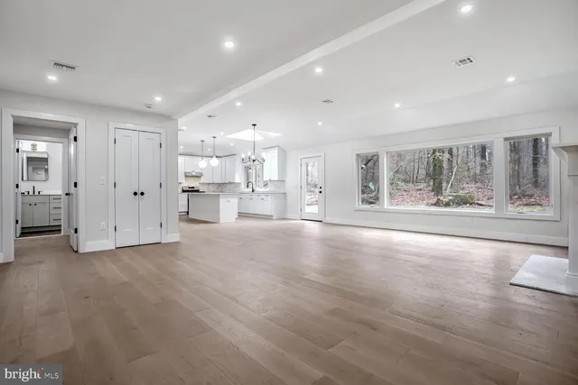 a view of a kitchen with large windows