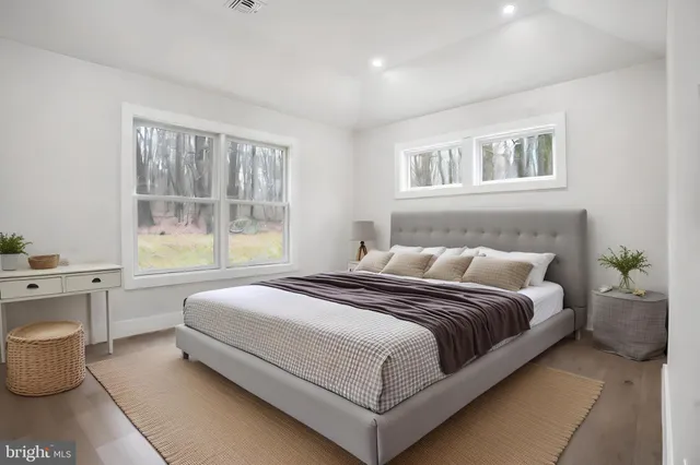 a bedroom with a large bed and a window
